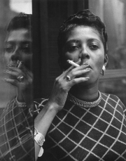 An African American woman smoking a cigarette in Harlem. New York, February 1956